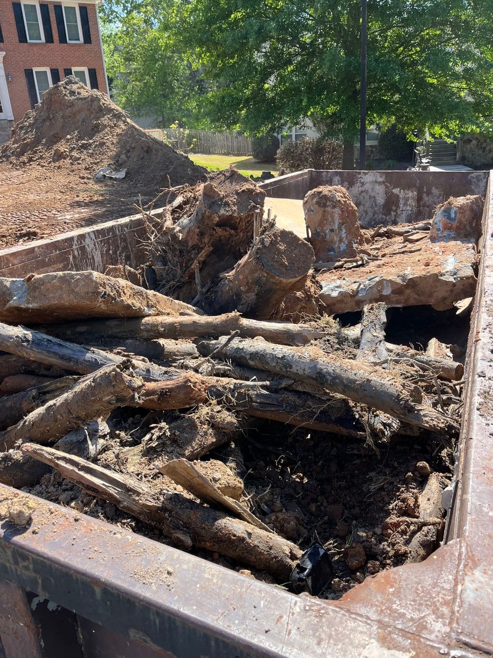 Debris and old materials in a dumpster during a residential renovation project.